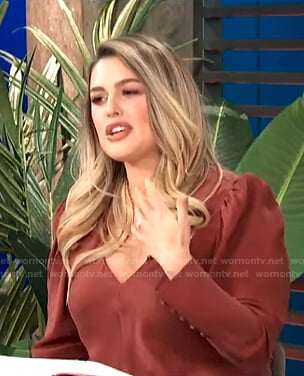 Carissa’s red v-neck puff sleeve top on E! News Daily Pop