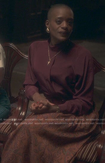 Hannah’s burgundy blouse and orange paisley skirt on The Haunting of Bly Manor