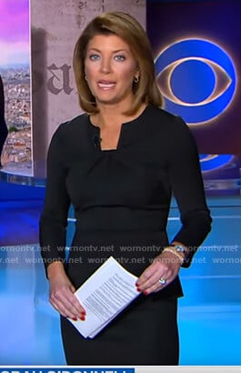 Norah’s black twisted neck peplum top on CBS Evening News