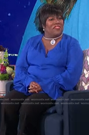 Sheryl’s blue ruffle cuff blouse on The Talk
