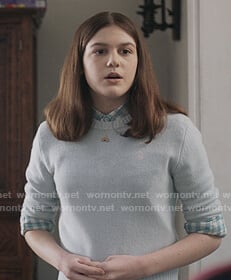 Addie’s blue peace sign embroidered sweater on The Unicorn