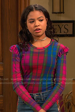 Nia’s pink plaid ruffle shoulder top on Ravens Home