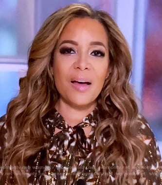 Sunny’s metallic floral tie neck blouse on The View