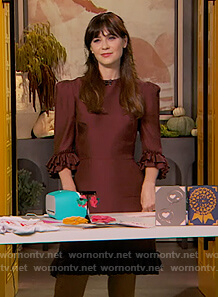Zooey Deschanel’s burgundy ruffle dress on The Drew Barrymore Show
