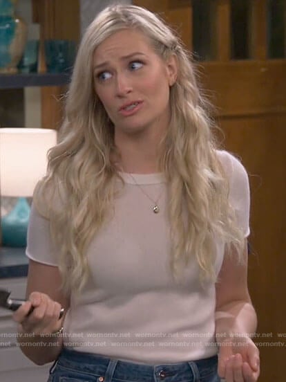 Gemma’s white short sleeve top and flared jeans on The Neighborhood
