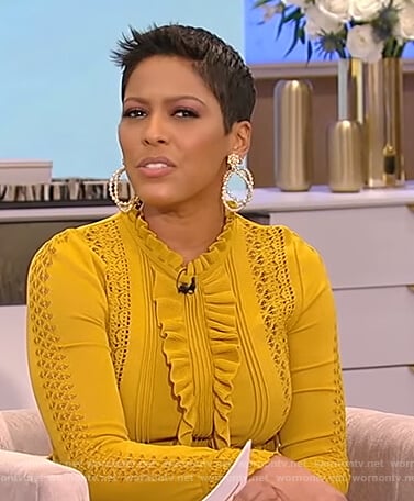 Tamron’s mustard ruffle knit sweater on Tamron Hall Show