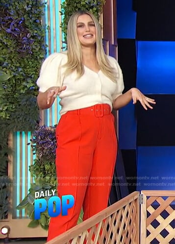 Carissa’s white cardigan and red belted pants on E! News Daily Pop