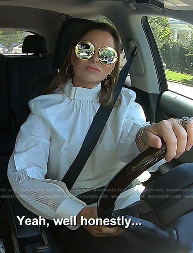D’Andra’s white buckle neck blouse on The Real Housewives of Dallas