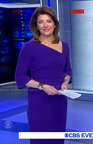 Norah’s blue asymmetric v-neck dress on CBS Evening News