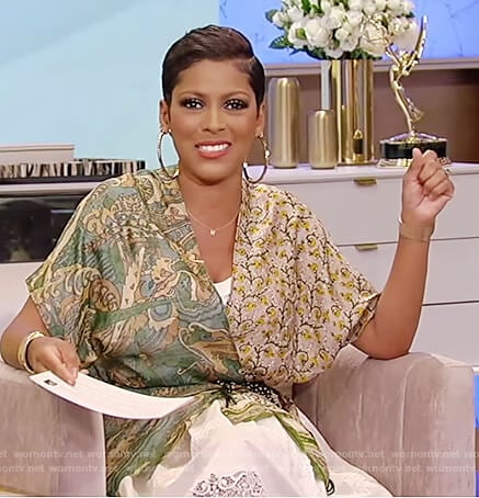 Tamron’s printed wrap blouse and white lace skirt on Tamron Hall Show