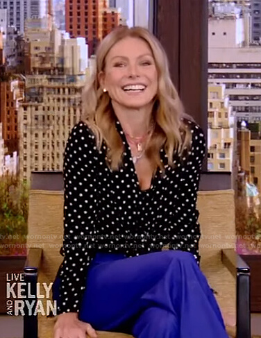 Kelly’s black polka dot blouse and blue pants on Live with Kelly and Ryan
