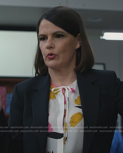 Maggie’s white floral tie neck blouse on All Rise
