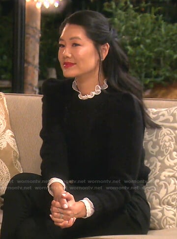 Crystal’s white ruffle neck blouse and black sweater on The Real Housewives of Beverly Hills
