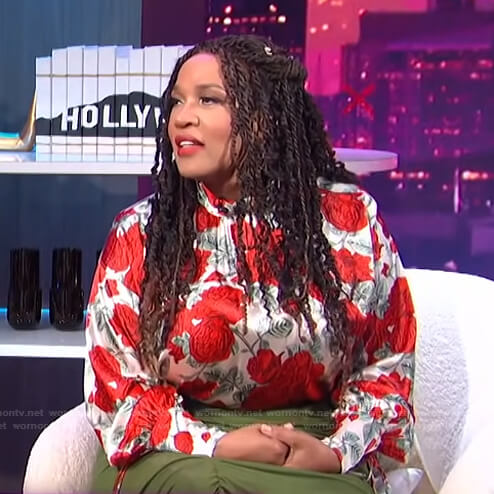 Kym’s floral mock neck blouse and green ruched skirt on E! News Nightly Pop