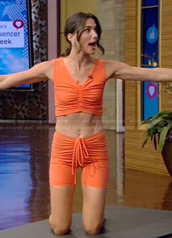 Melissa Wood-Tepperberg’s orange ruched sport bra and biker shorts on Live with Kelly and Ryan