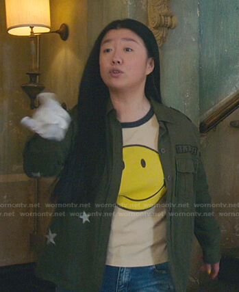 Alice’s beige smiley face tee and green star jacket on Good Trouble