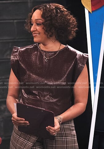 Cocoa’s brown crocodile leather top and plaid wrap-effect pants on Family Reunion