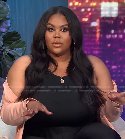 Nina’s black top and pink cardigan on E! News Nightly Pop
