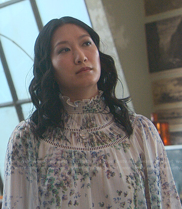Sumi’s white floral ruffle neck blouse on Good Trouble