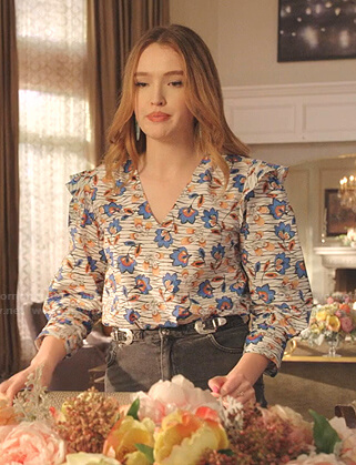 Kirby’s white floral v-neck top and buckle denim skirt on Dynasty