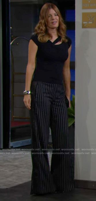 Phyllis’s navy asymmetric cutout top and pinstripe pants on The Young and the Restless
