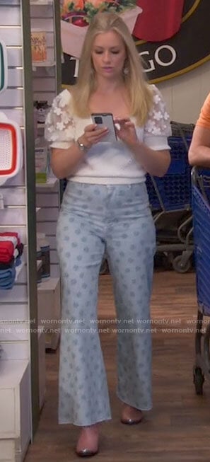 Gemma’s floral puff sleeve top and daisy print jeans on The Neighborhood