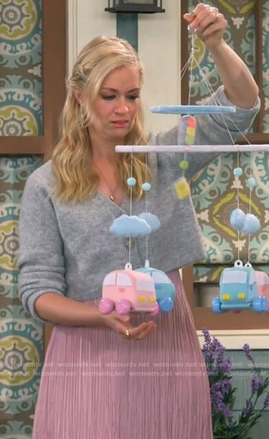 Gemma’s pink pleated dress and grey cardigan on The Neighborhood