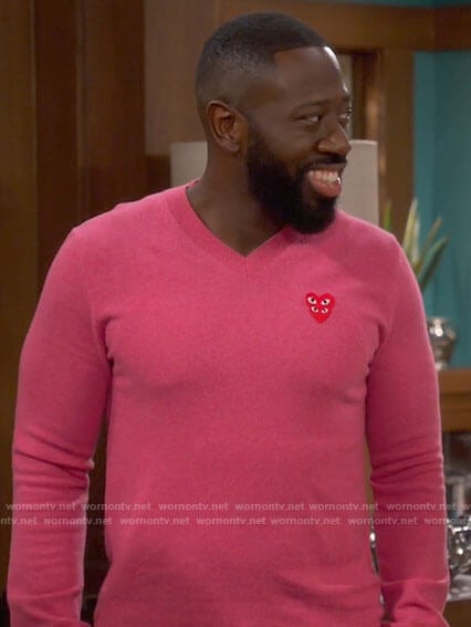Malcolm’s pink heart sweater on The Neighborhood