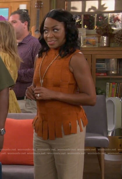 Tina’s orange basketweave top on The Neighborhood