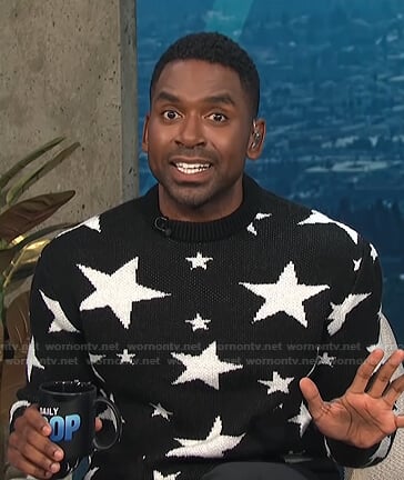Justin’s black star print sweater on E! News Daily Pop