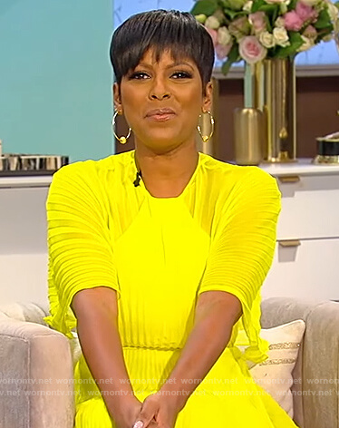 Tamron’s neon yellow pleated dress on Tamron Hall Show