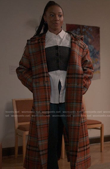 Whitney’s long plaid coat and layered corset shirt on The Sex Lives of College Girls