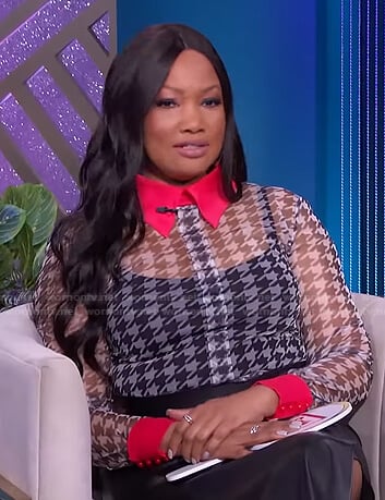 Garcelle’s houndstooth sheer top with pink collar on The Real