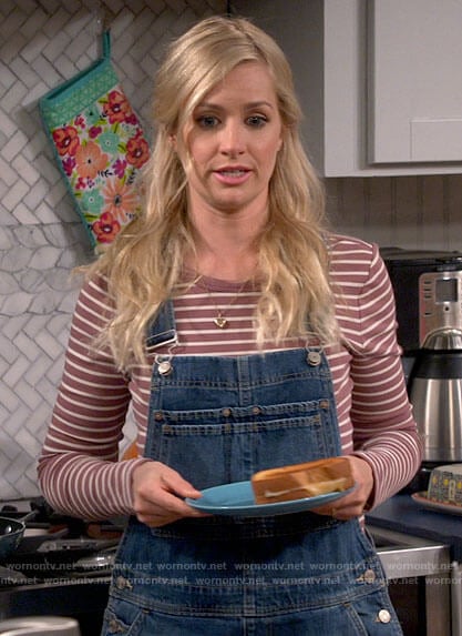 Gemma’s mauve striped top and denim overalls on The Neighborhood