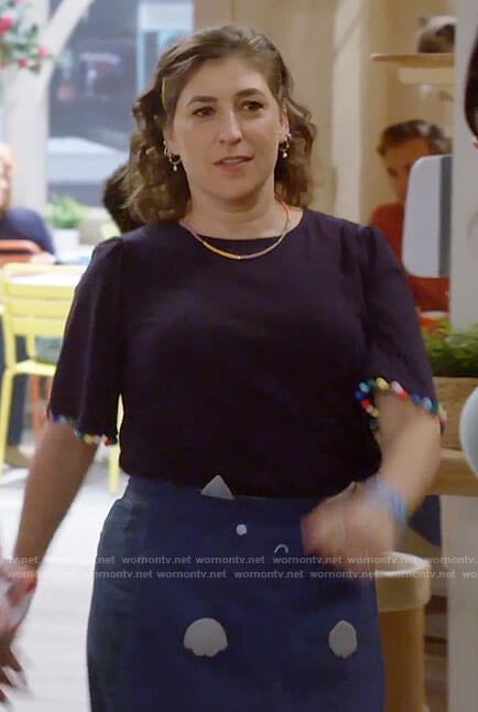 Kat’s navy top with rainbow pom pom trim on Call Me Kat
