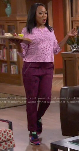 Tina’s pink leopard sweater and sweatpants on The Neighborhood