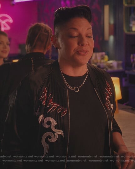 Che’s black embroidered bomber jacket on And Just Like That