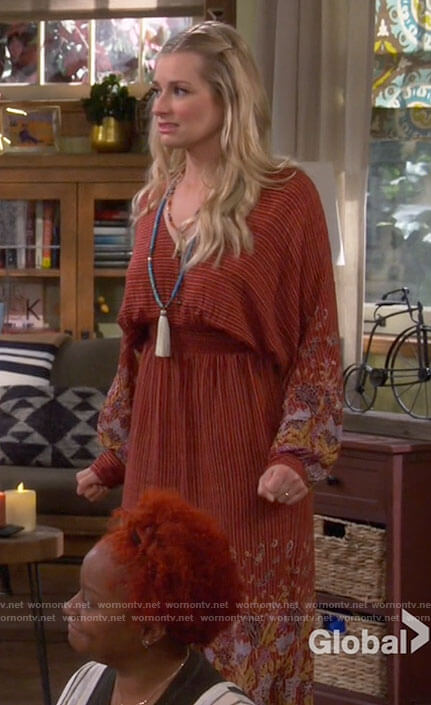 Gemma’s red floral jumpsuit on The Neighborhood