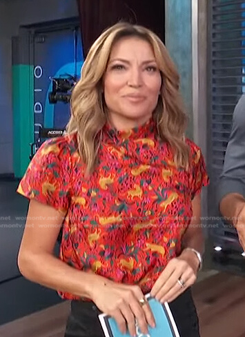 Kit’s red animal print short sleeve top on Access Hollywood
