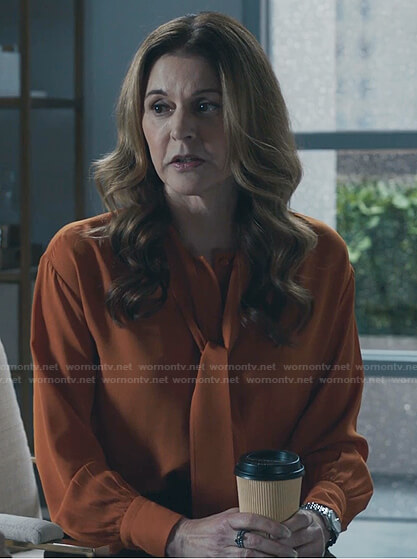 Kit’s orange tie neck blouse on The Resident