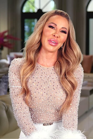 Lisa’s Embellished feather cuff jumpsuit on The Real Housewives of Miami