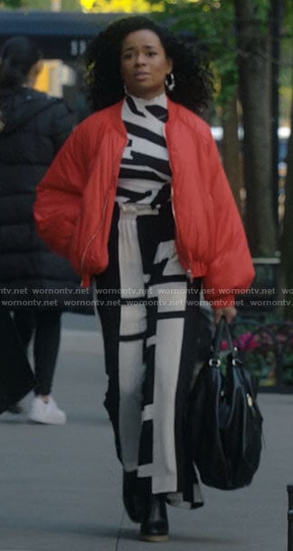 Neff’s orange bomber jacket and black and white top on Inventing Anna