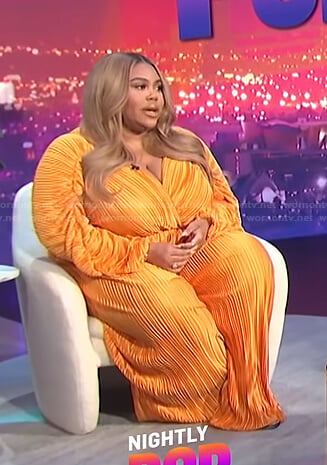 Nina’s orange pleated wrap top and pants on E! News Nightly Pop