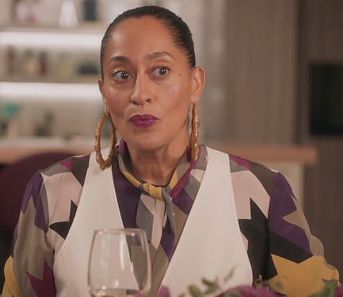 Rainbow’s houndstooth tie neck blouse on Black-ish