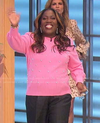 Sheryl’s pink pearl embellished sweater and sneakers on The Talk