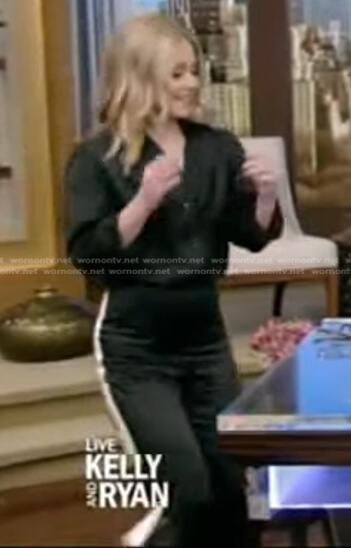 Kelly’s black blouse and side striped pants on Live with Kelly and Ryan