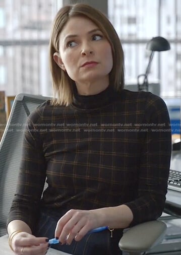 Taylor’s black check turtleneck top on Bull