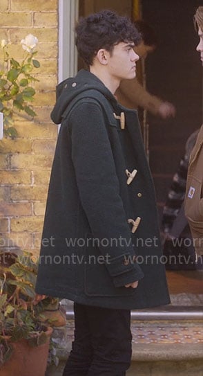Charlie’s green toggle coat and blue backpack on Heartstopper