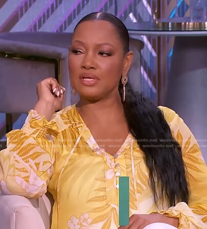 Garcelle’s yellow floral tie neck top on The Real