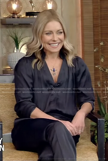 Kelly’s black satin jumpsuit and yellow pumps on Live with Kelly and Mark